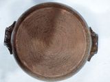 a brown pot sitting on top of a white table