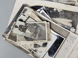 a pile of old black and white photos on a table