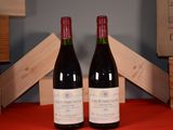 two bottles of wine sitting next to each other on a table