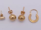 three pairs of gold earrings and a pair of earrings