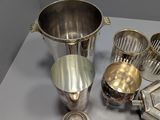 a lot of silver items sitting on a table