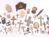 a lot of crosses and other religious items on the table