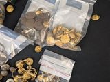 a lot of gold and silver buttons on a black table
