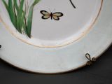 a plate with a butterfly and a flower on it