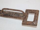 an old rusted metal handle with a hole in the middle