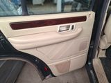 the interior of a car with the door open and the driver ' s seat down