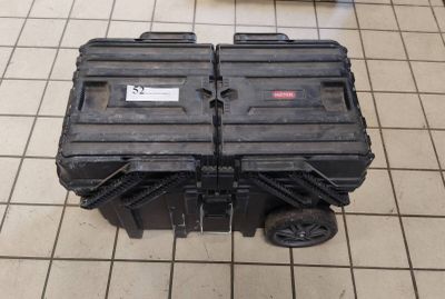 a black tool box sitting on a tiled floor