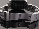a close up of a wrist watch on a reflective surface