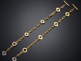 a pair of gold and diamond bracelets