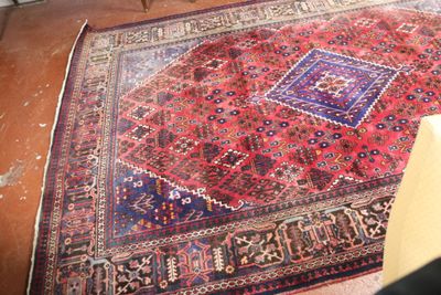 a rug on the floor with a chair in front of it