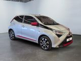 the toyota ay is parked in a showroom with white walls and a black floor