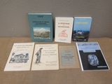 several books sitting on a table next to each other on top of a table