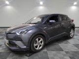 the gray toyota c - hr is parked in a room with a checkered floor