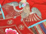 a red cloth with a picture of a bird on it