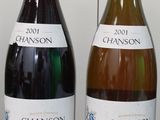 three bottles of wine are lined up on a table