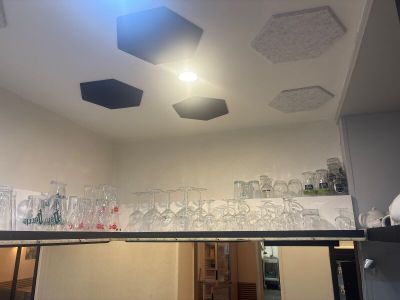 a lot of empty glasses on the shelf in the room