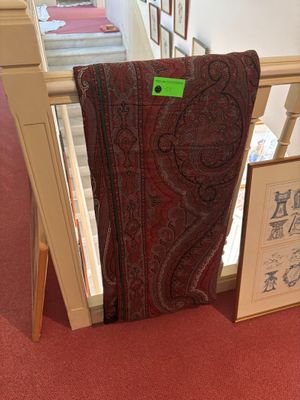 a chair that is sitting in a room with pictures on the wall