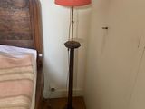 a bed with a wooden headboard and a lamp on it