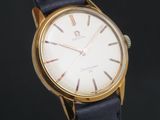 a close up of a gold wrist watch with a black strap