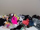 a pile of clothing on a white table in a room