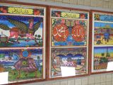 many pictures of different countries on the wall of a building