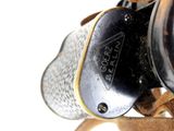 a close up of a camera with a leather strap around it