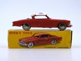 a red toy car sitting on top of a box