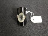 a close up of a ring on a table with a price tag