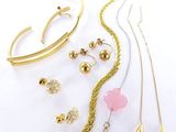 many different types of jewelry on a white surface