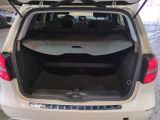 the back of a car with its trunk open and luggage in the trunk