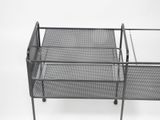 a metal shelf that has a glass top on it