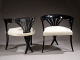 pair of black and white chairs with white upholstered seats