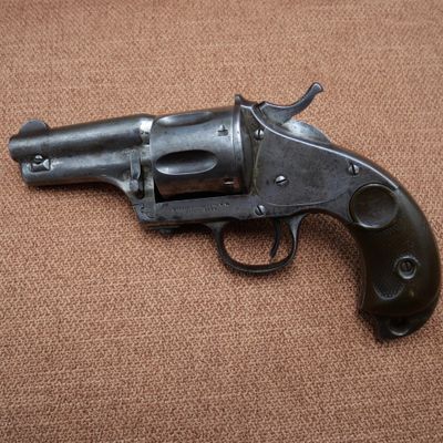 a close up of a gun on a brown surface