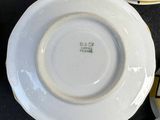 many plates and cups sitting on a table