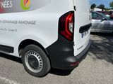 a white van parked in a parking lot with other cars