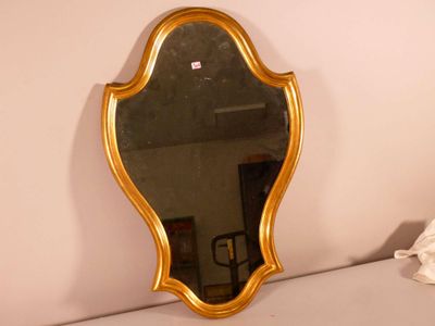 a mirror that is sitting on the wall next to a bed