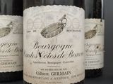 three bottles of wine are lined up on a table