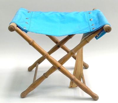 a small stool with a blue cover on it