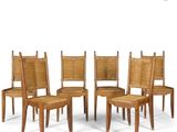 four wooden chairs with cane backrests on a white background