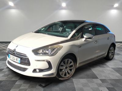 the white car is parked on a checkered floor in the garage