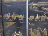 a picture of a screen with a painting of people riding on camels