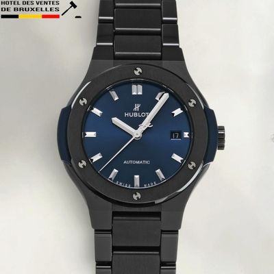 a picture of a black watch with a blue dial