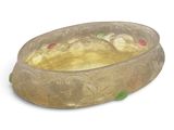 a glass bowl that has a gold design on it