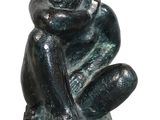 statue of a man sitting on a base with his hands on his knees