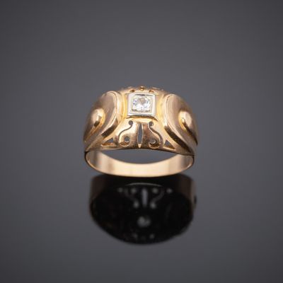 a gold ring with a diamond set in the center
