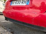 a red car that is parked on the side of the street