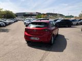 a red car parked in a parking lot next to other cars