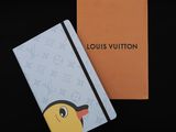 a louis vuitton notebook with a yellow bird on it