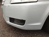 a close up of the front bumper of a white car