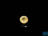 a close up of a yellow diamond on a black surface